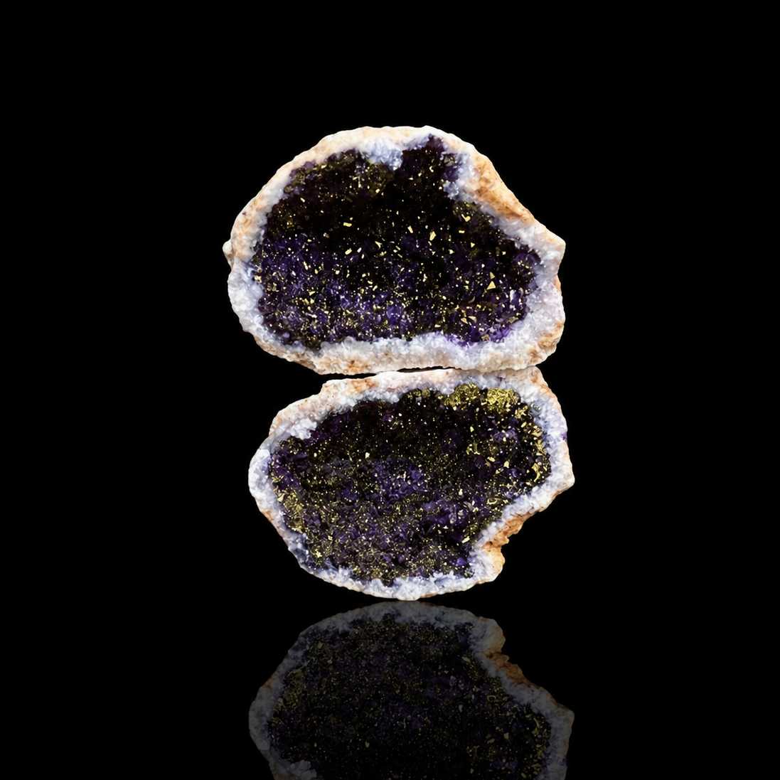 Geode split open revealing a purple interior on a black background