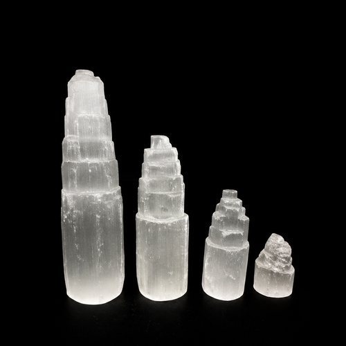 Set of five crystal towers of varying sizes on a black background