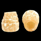 Pair of natural red selenite candle holders made from Moroccan selenite on black background