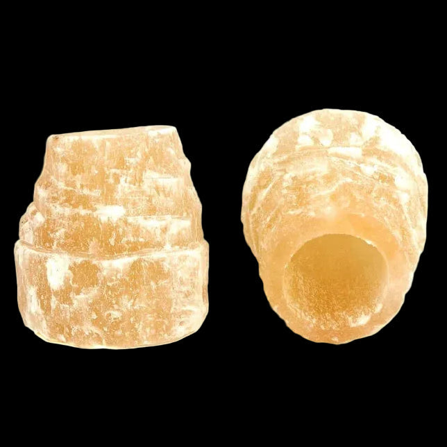 Pair of natural red selenite candle holders made from Moroccan selenite on black background