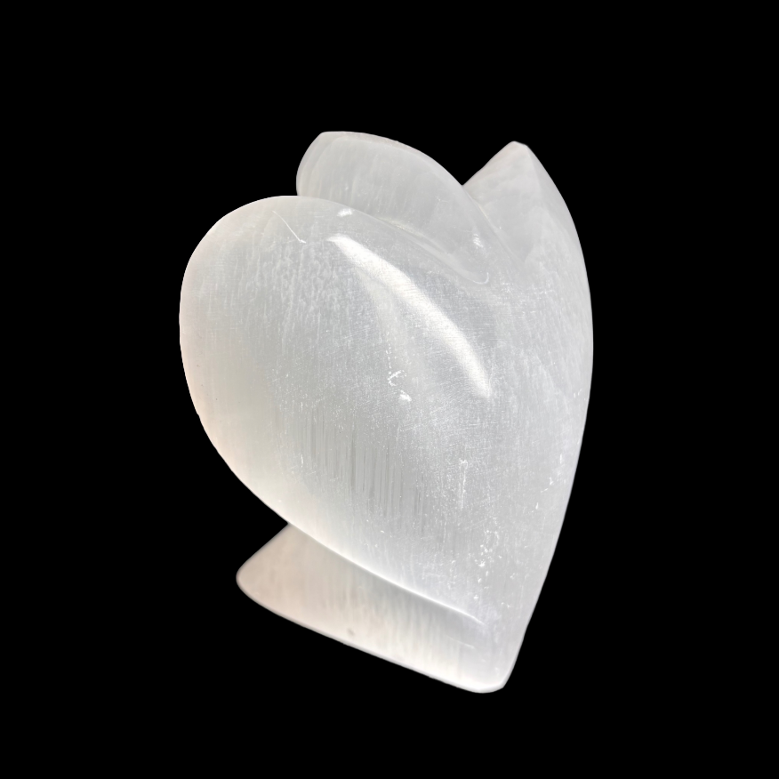 Side view of 10cm carved selenite angel crystal showing natural stone detail on black background