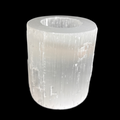 Natural selenite candle holder with polished top and raw sides carved from Moroccan selenite on black background