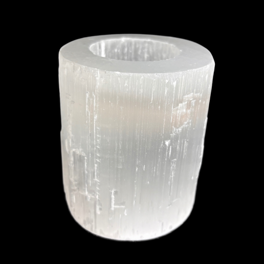 Natural selenite candle holder with polished top and raw sides carved from Moroccan selenite on black background