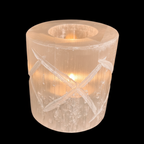 Lit tealight inside natural selenite diamond candle holder creating soft warm glow