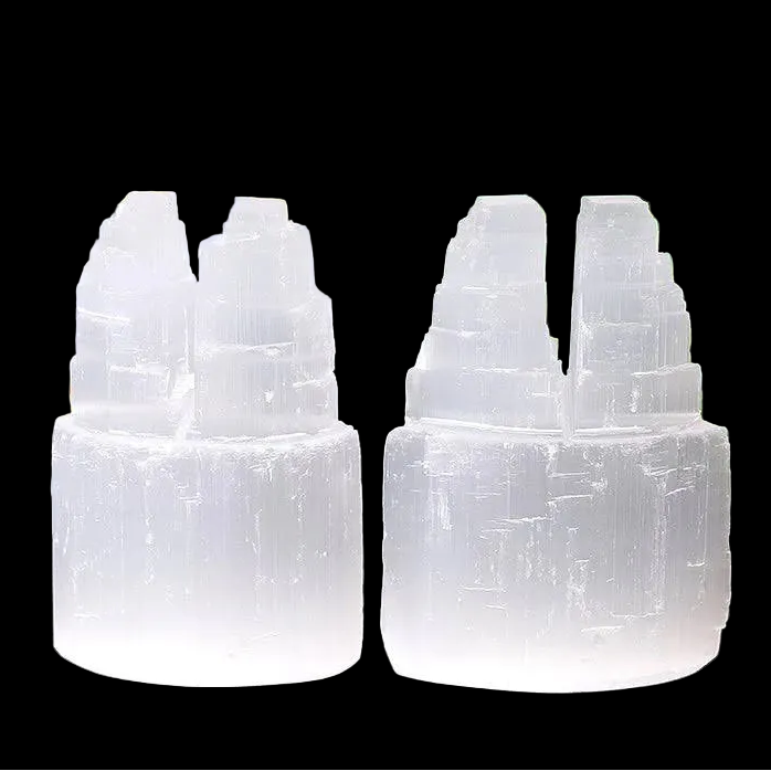 Pair of natural selenite double mountain tower crystals carved from Moroccan selenite on black background