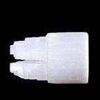 Side view of polished selenite double mountain tower crystal carved from natural Moroccan selenite on black background