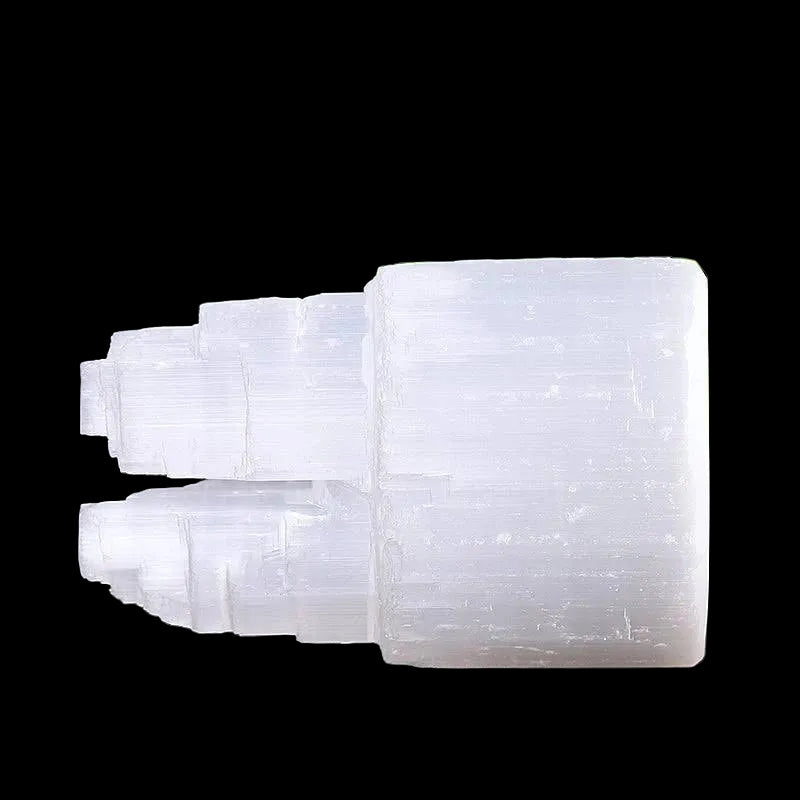 Side view of polished selenite double mountain tower crystal carved from natural Moroccan selenite on black background