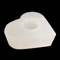 Heart shaped natural selenite candle holder with polished top carved from Moroccan selenite on black background
