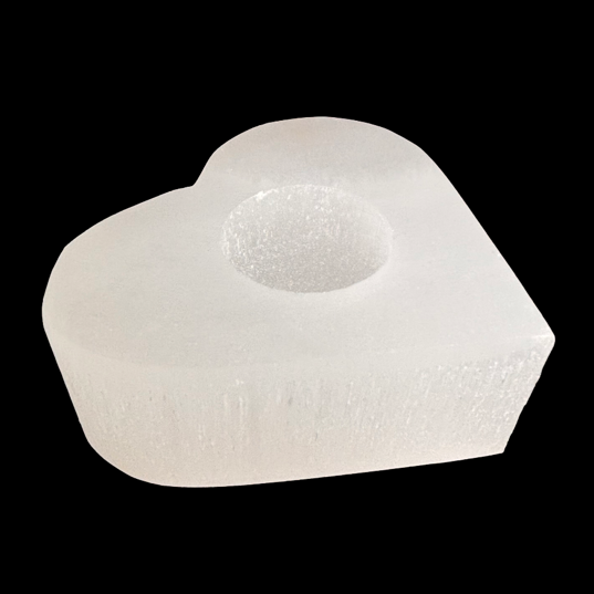 Heart shaped natural selenite candle holder with polished top carved from Moroccan selenite on black background