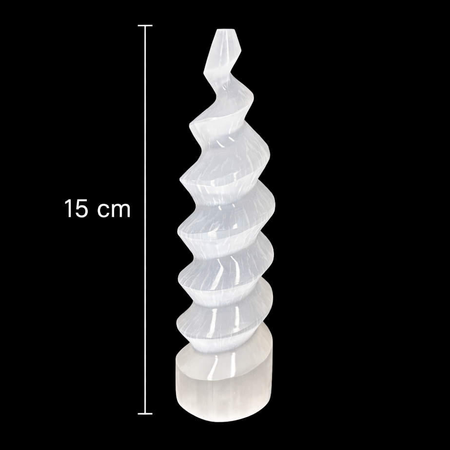 15cm polished selenite spiral tower crystal on black background with measurement scale