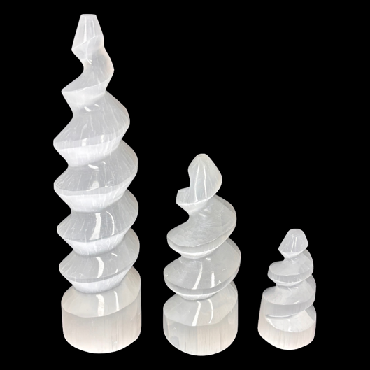 Polished selenite spiral tower crystal set in 5cm 10cm and 15cm sizes on black background