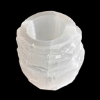 Front view of natural selenite tealight holder showing layered carved crystal texture