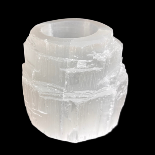 Natural selenite tealight candle holder carved from Moroccan selenite on black background